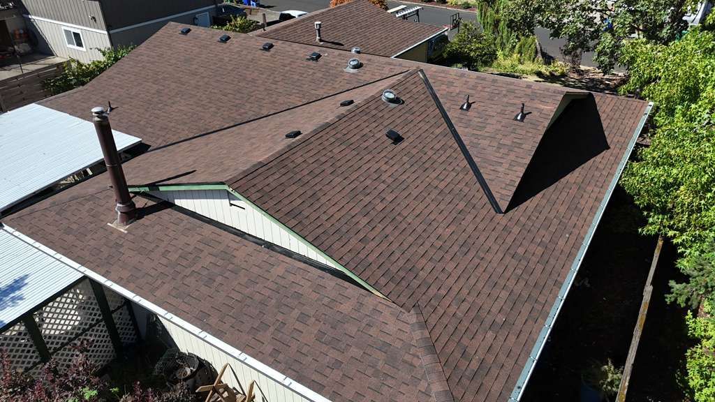 Aerial of the finished brown Malarkey Highlander shingle roof with clean ridge lines and new vents
