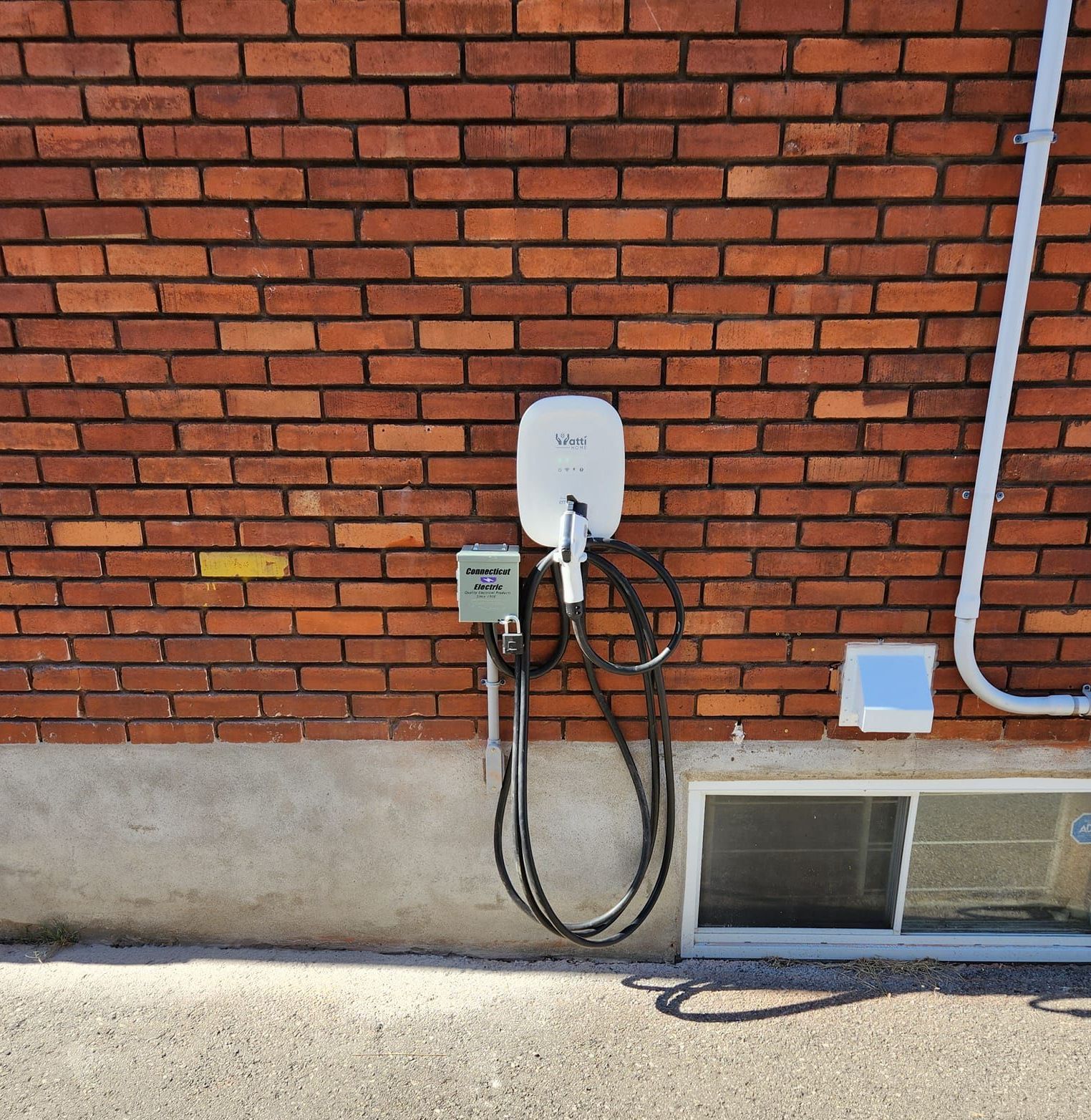 A brick wall with a charger attached to it