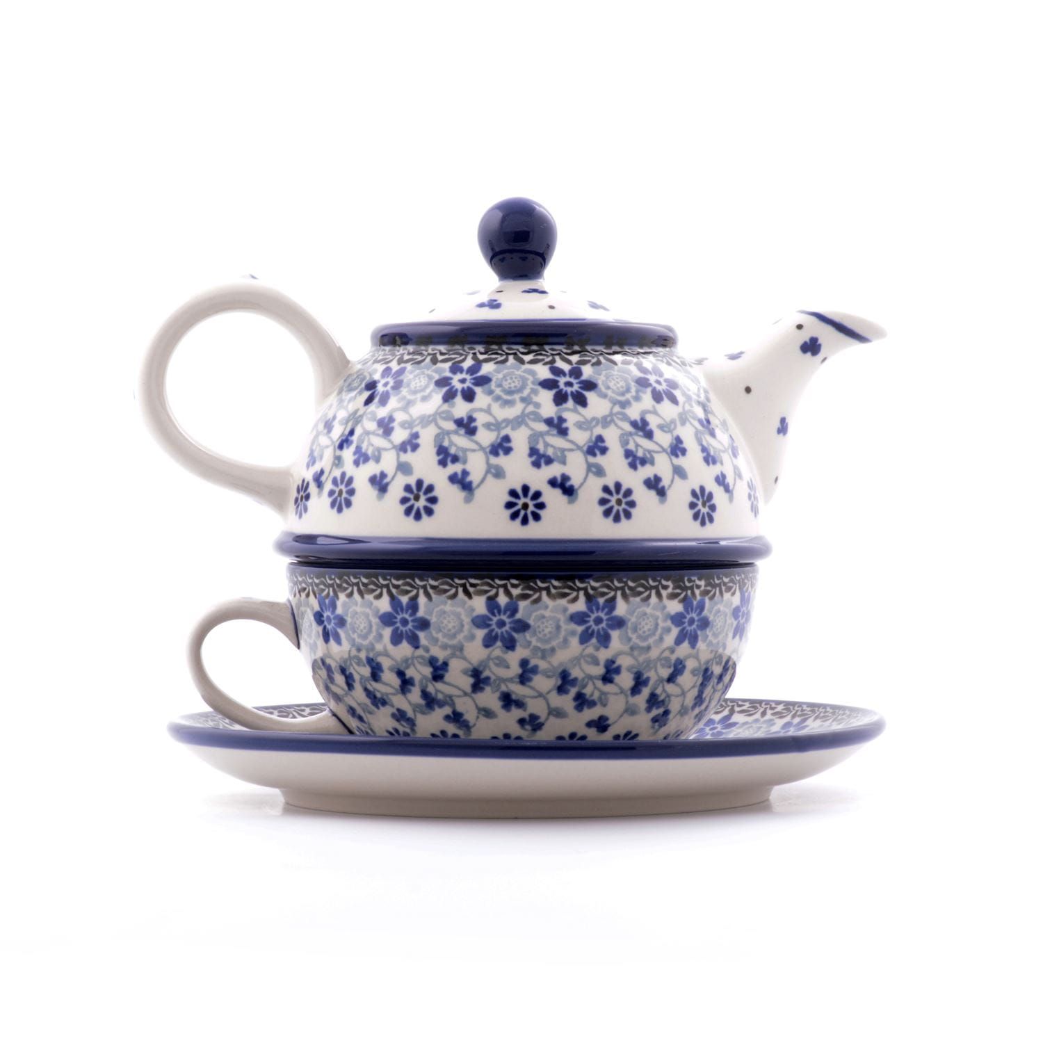 Keramische theepot, kopje en schotelset met blauw bloemenpatroon op een witte achtergrond.
