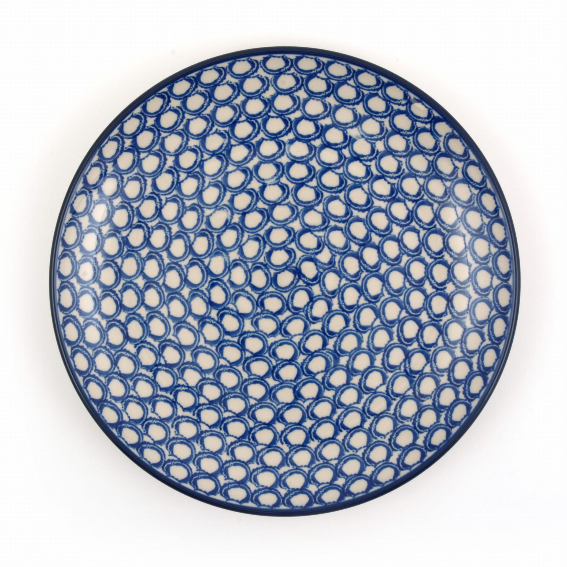 Blauw-wit keramisch bord met een herhalend cirkelpatroon.