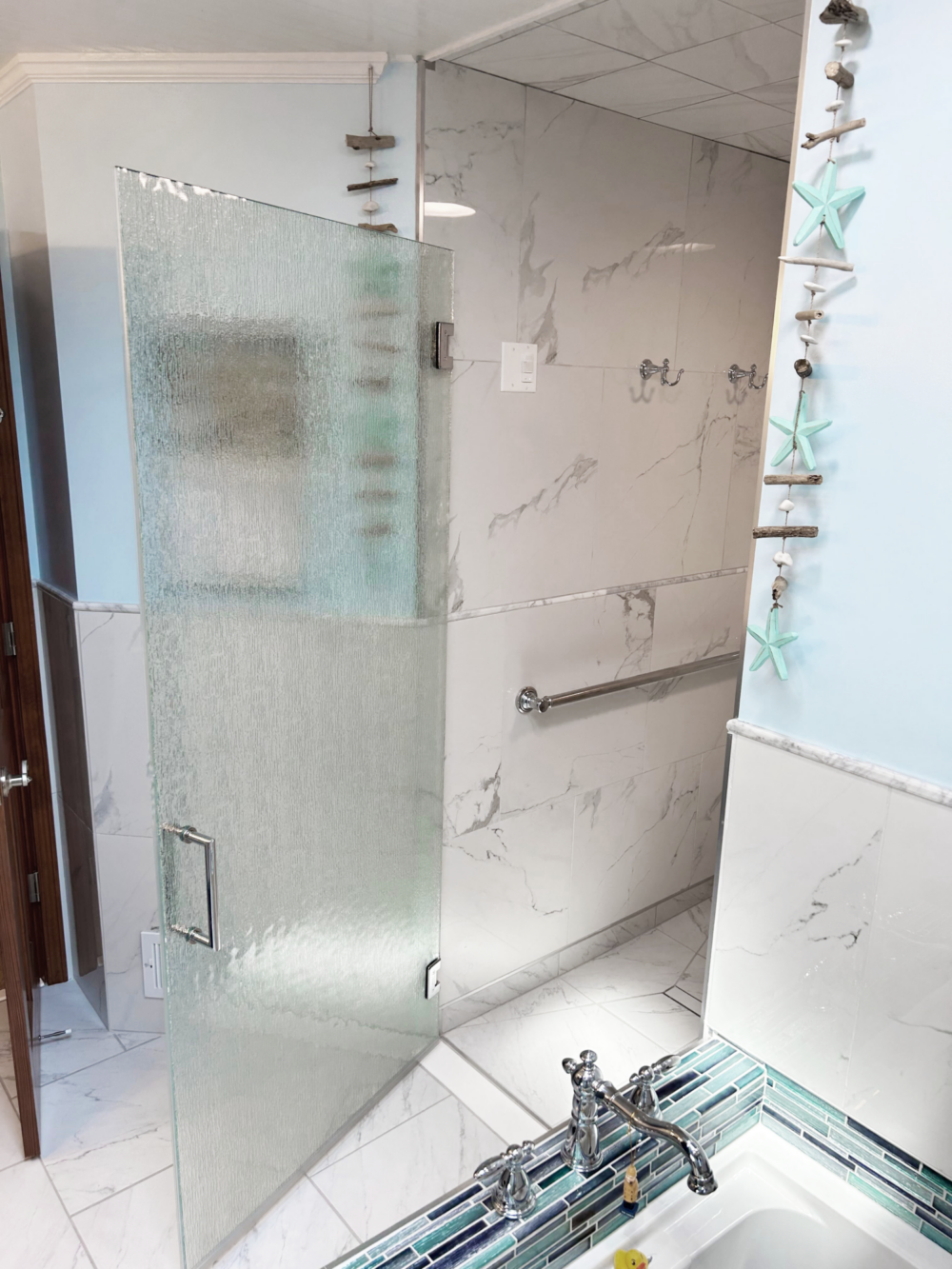 Lux Single Swing Door featuring Rain Glass and Chrome Metal Finish.