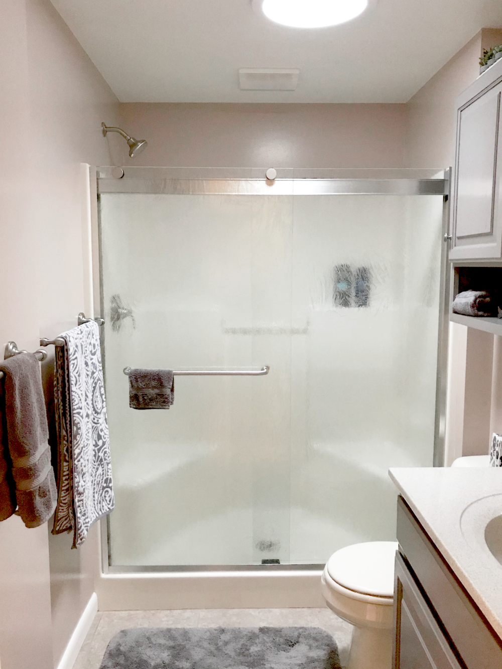 Rotolo 905 Bypass shower door featuring Tempest textured privacy glass with Brushed Nickel metal finish.