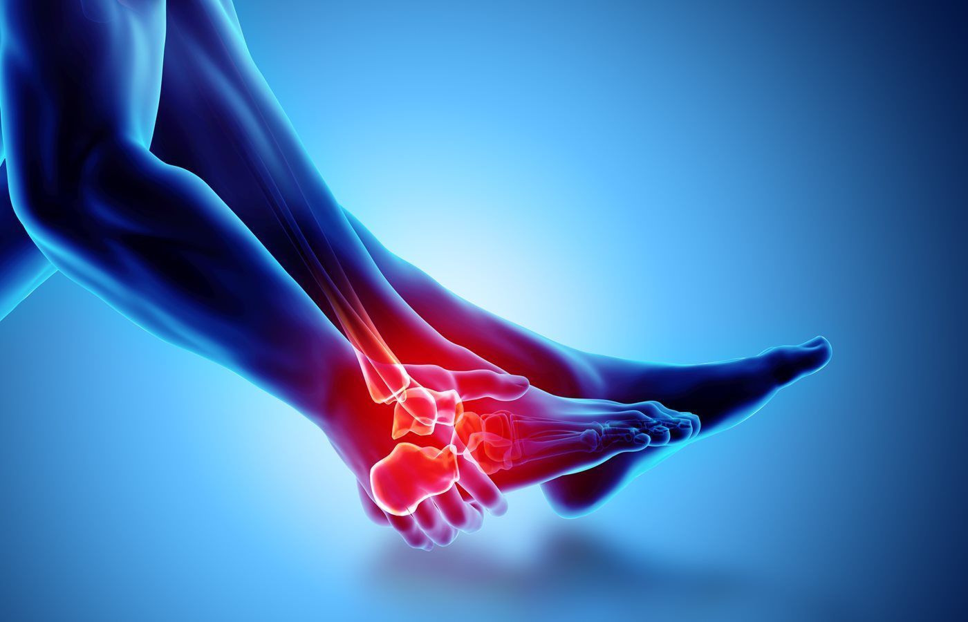 A person is holding their ankle in pain.