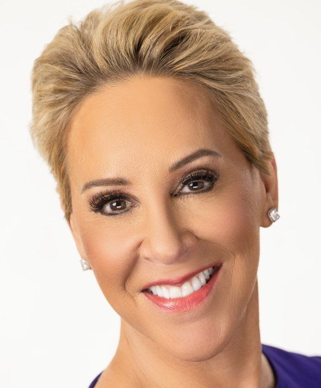 A close up of a woman 's face with a smile on her face.