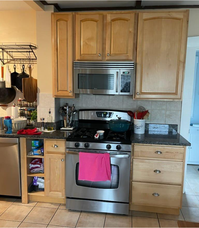 A kitchen with a stove a refrigerator and a dishwasher