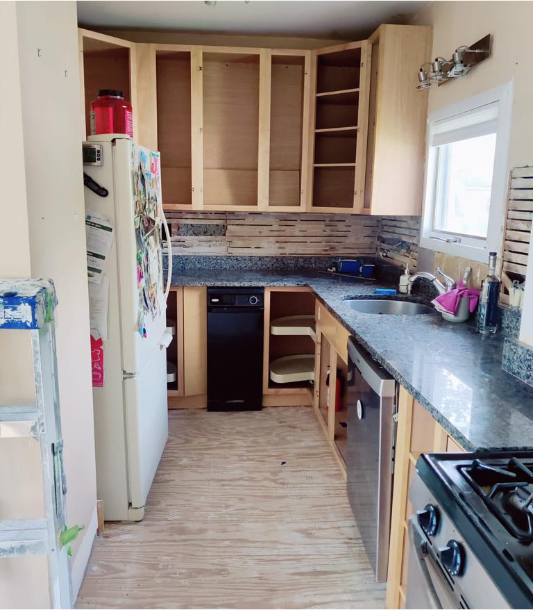 A kitchen with stainless steel appliances and wooden cabinets
