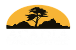 Acadia Landscape Logo - silhouette of a lone acacia tree and rocks against a yellow-orange sunset sky
