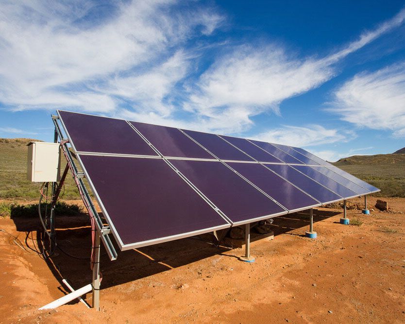 Solar Panels In A Dirt Field With A Blue Sky In The Background — High-Quality Solar Panels in Gunnedah