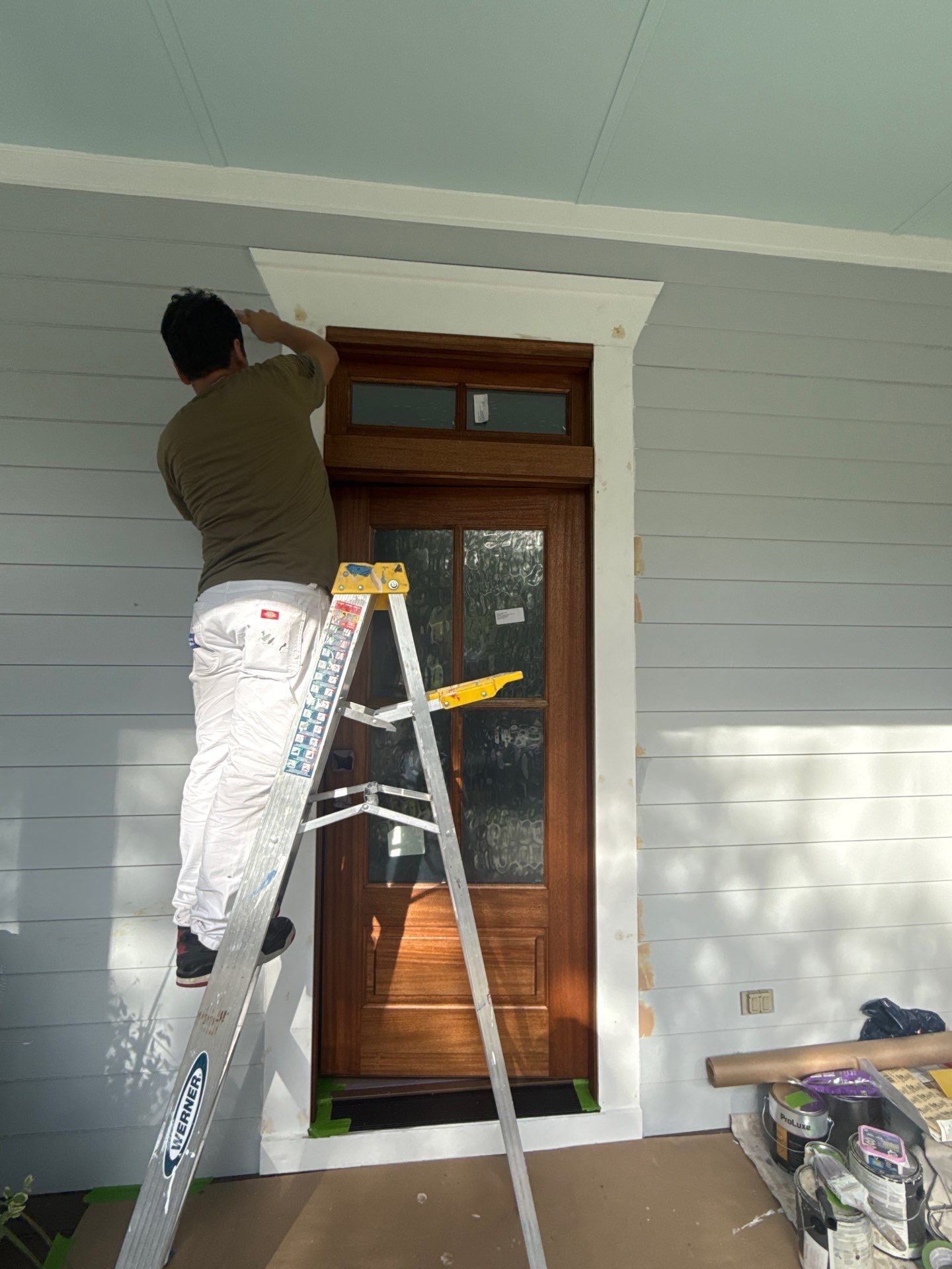A man is painting a wall.