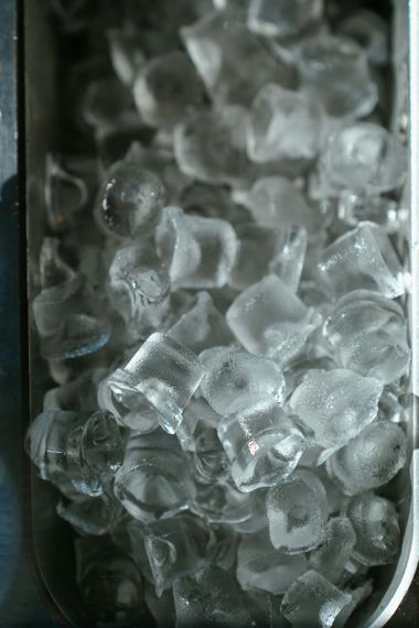 Clear ice cubes in a glass container