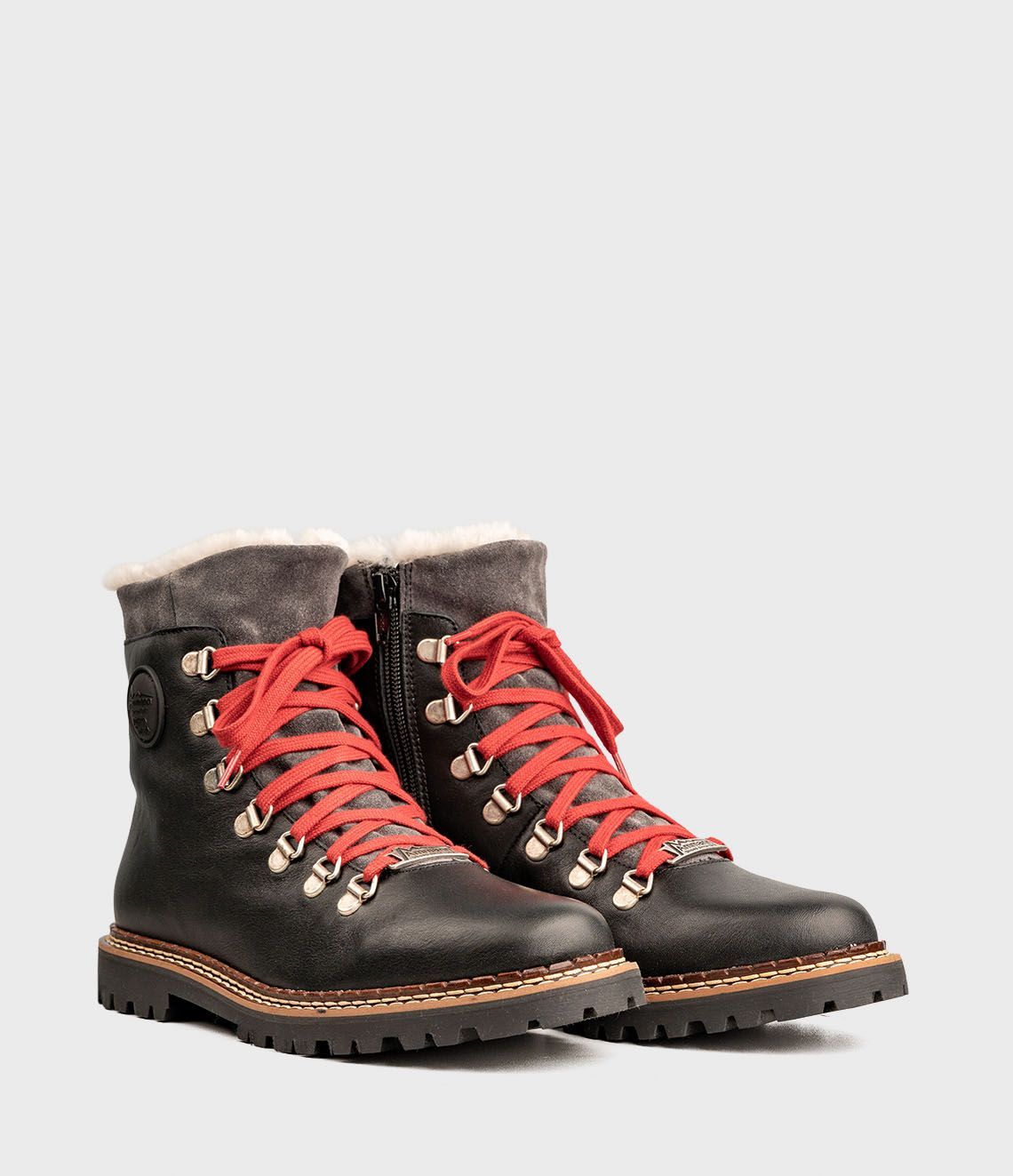 Bottes d'hiver en cuir noir avec lacets rouges et doublure en fourrure grise.