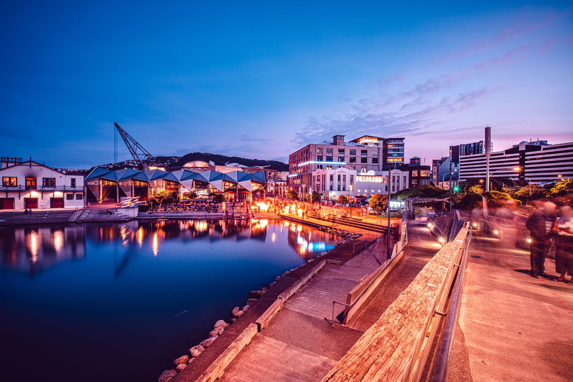 Evening waterfront view of Wellington city with lights reflecting on the harbour