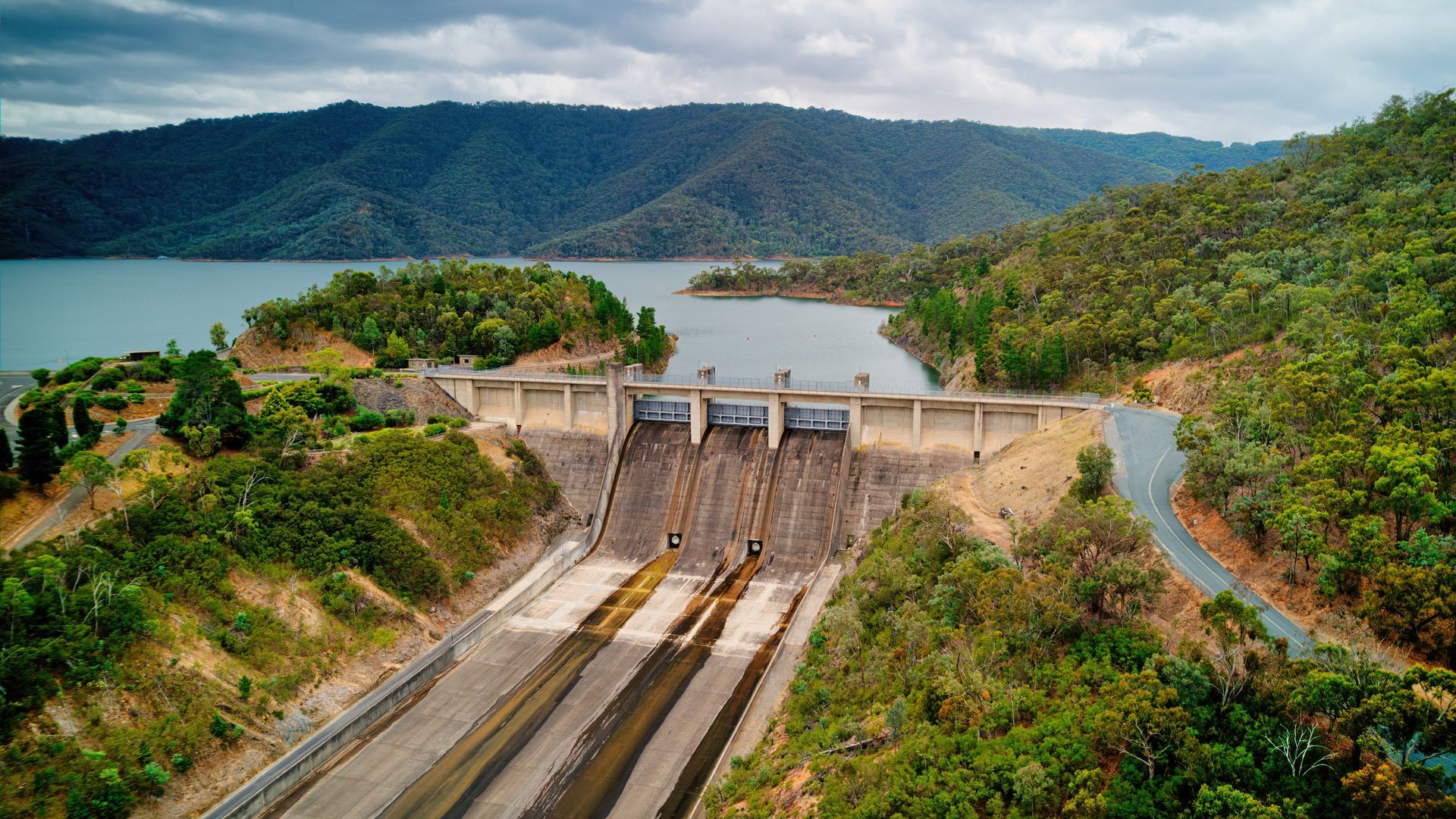 Hydroelectric dam and reservoir surrounded by hills