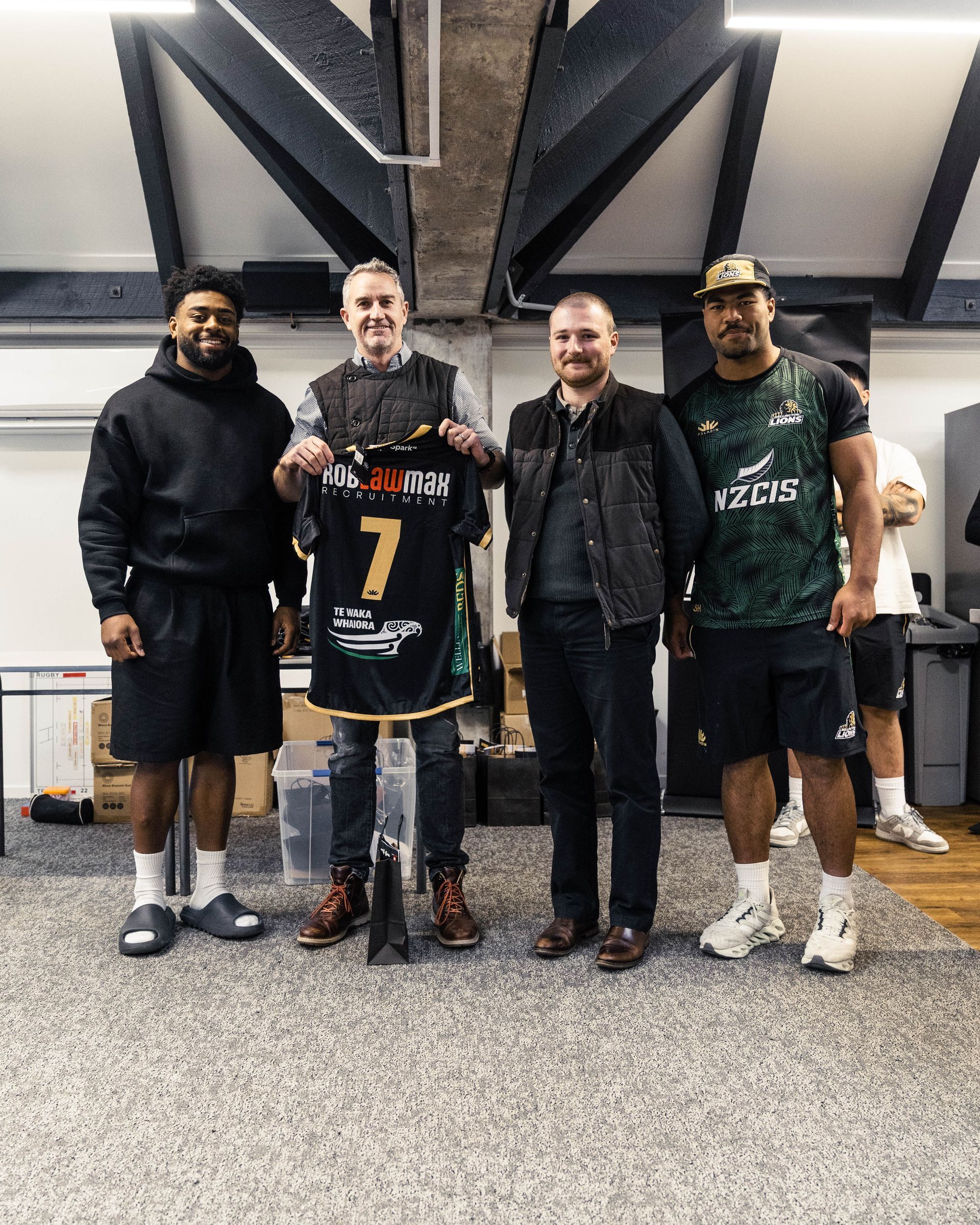 RobLawMax presenting a sponsored jersey to Wellington Lions players