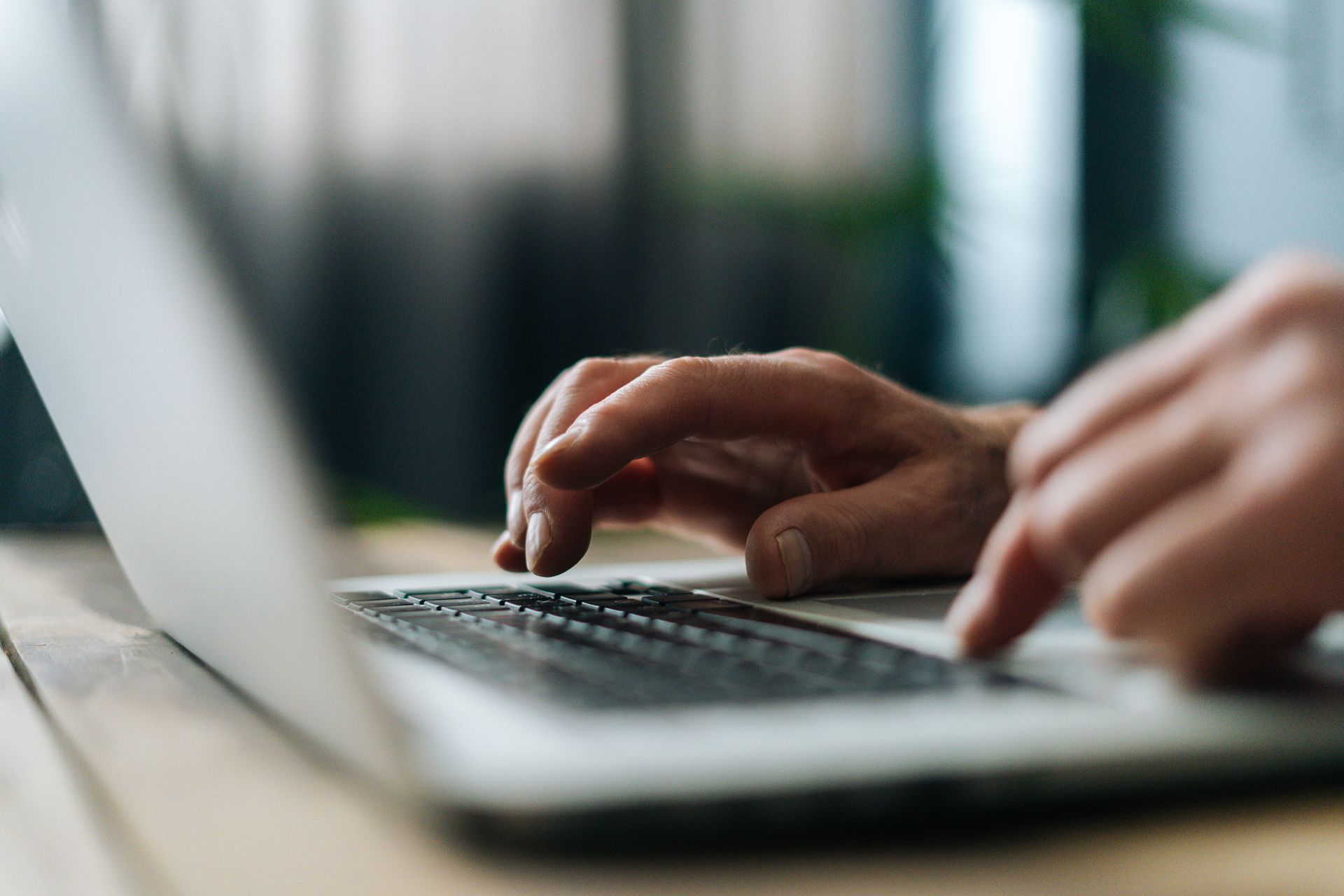 Person typing on a laptop during workplace safety reporting