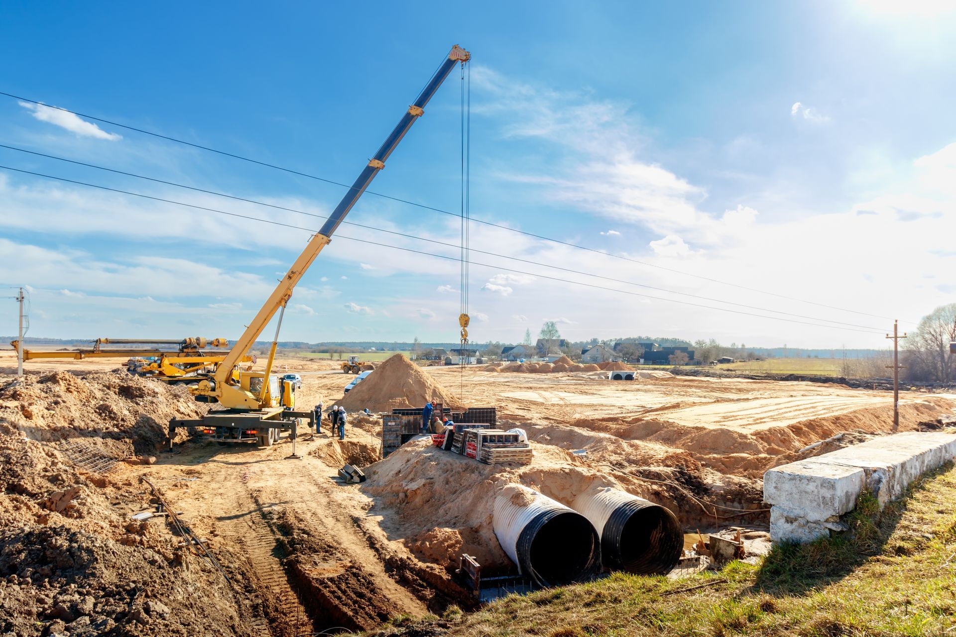 Crane and pipeline installation on construction site