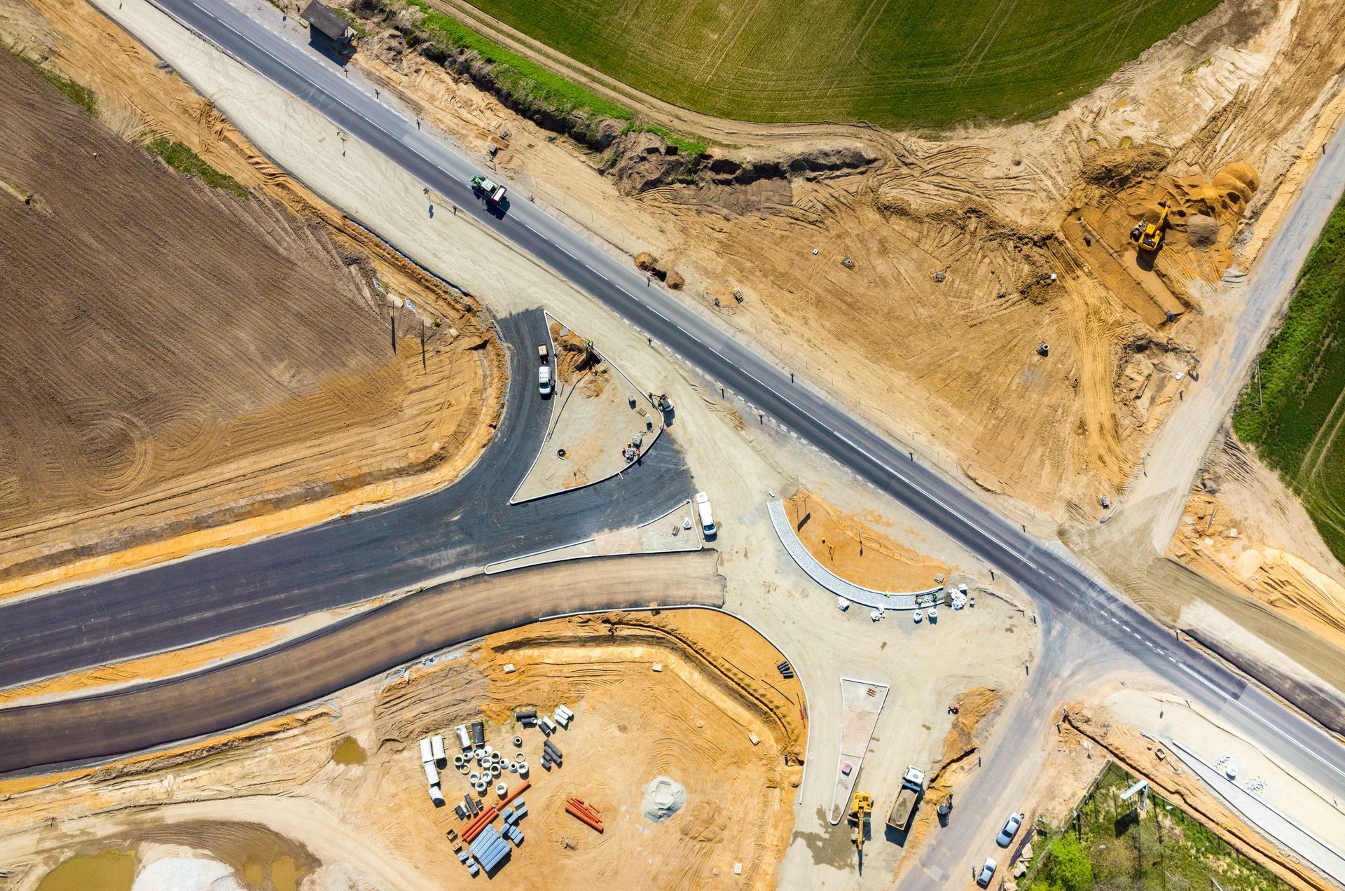 Aerial view of a road construction site with heavy machinery
