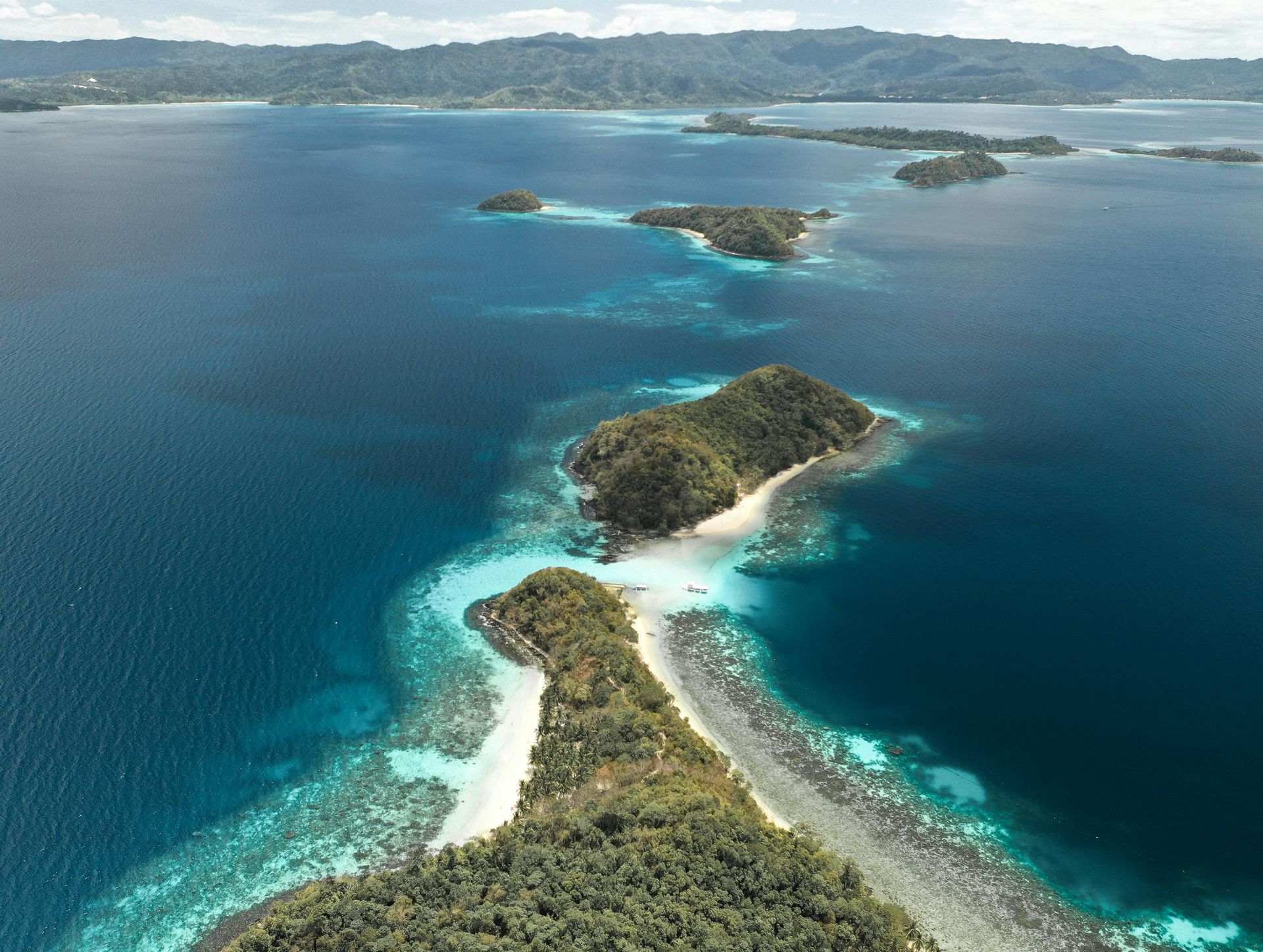 An aerial view of a tropical island in the middle of the ocean