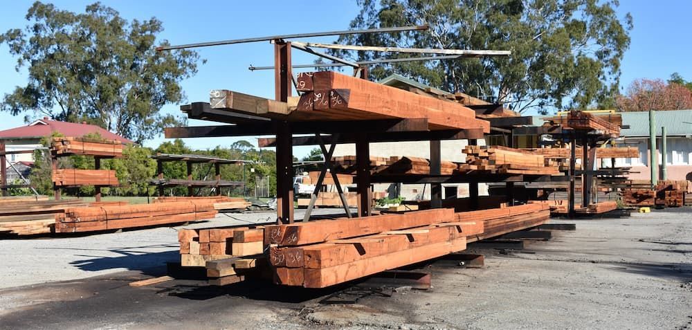 A Bunch of Logs Are Stacked on Top of Each Other in A Yard — Budget Timbers in North Lismore, NSW