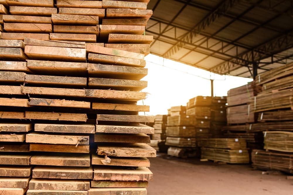 A Warehouse Filled with Lots of Wooden Boards Stacked on Top of Each Other — Budget Timbers in Grafton, NSW