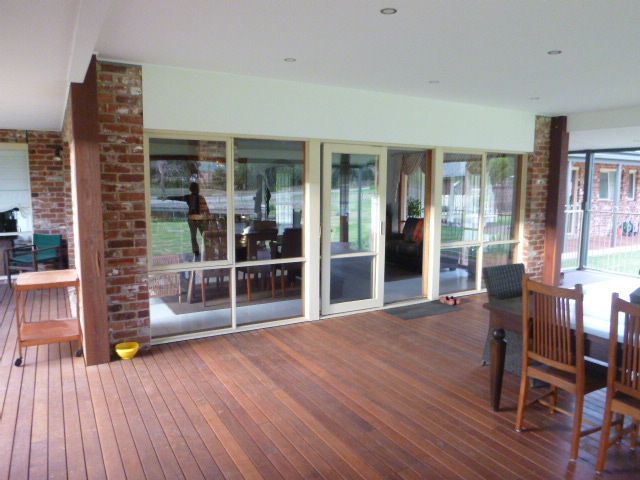 A Large Room with A Wooden Deck and Sliding Glass Doors — Budget Timbers in North Lismore, NSW