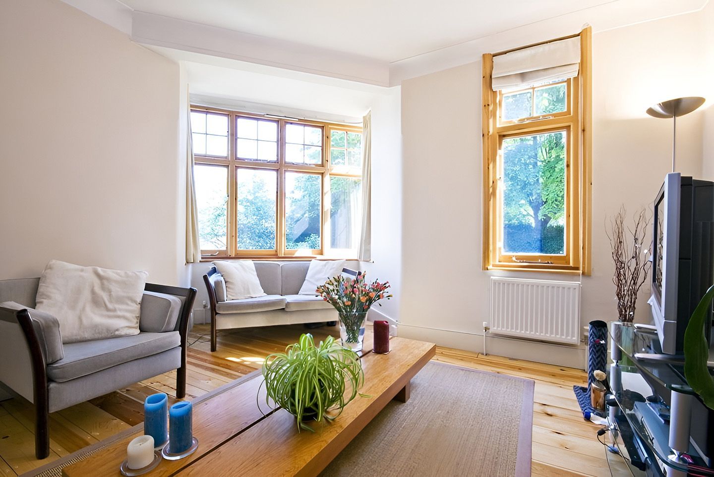 Modern Living Room Featuring Timber Window Frames And Flooring