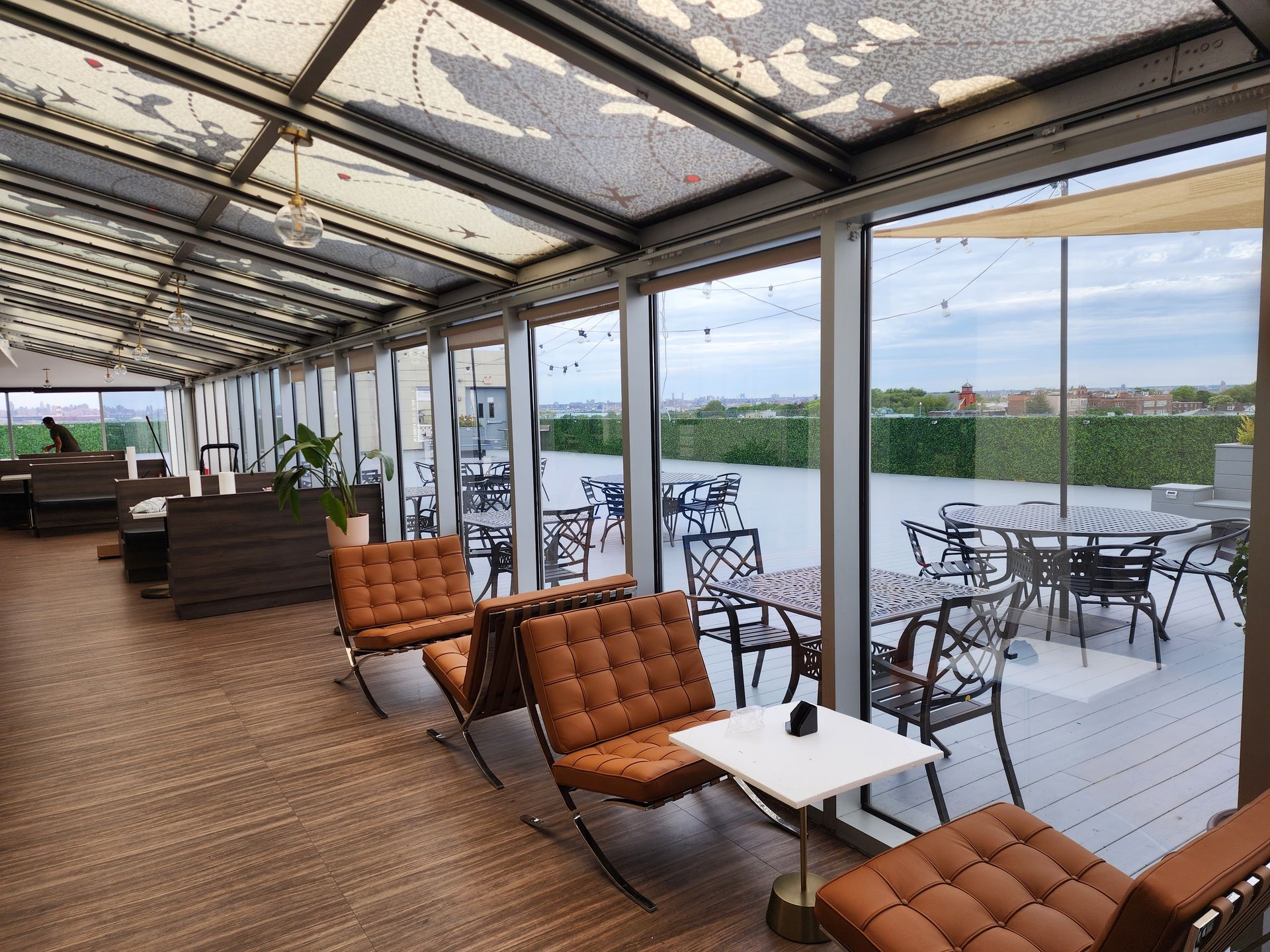 A restaurant with tables and chairs and a large window