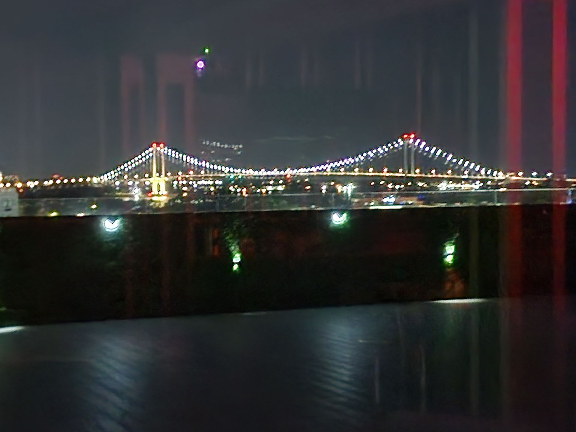 A view of a bridge at night through a window