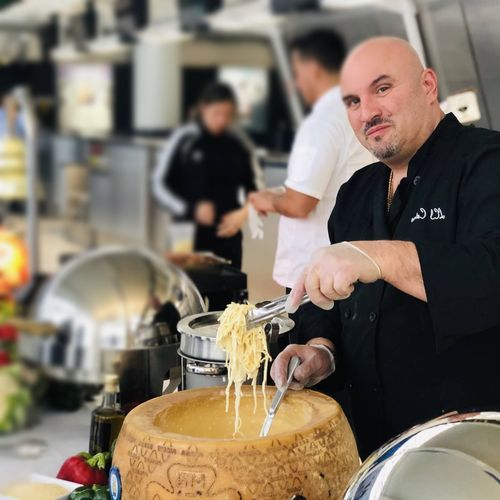 A man in a chef 's uniform is preparing food