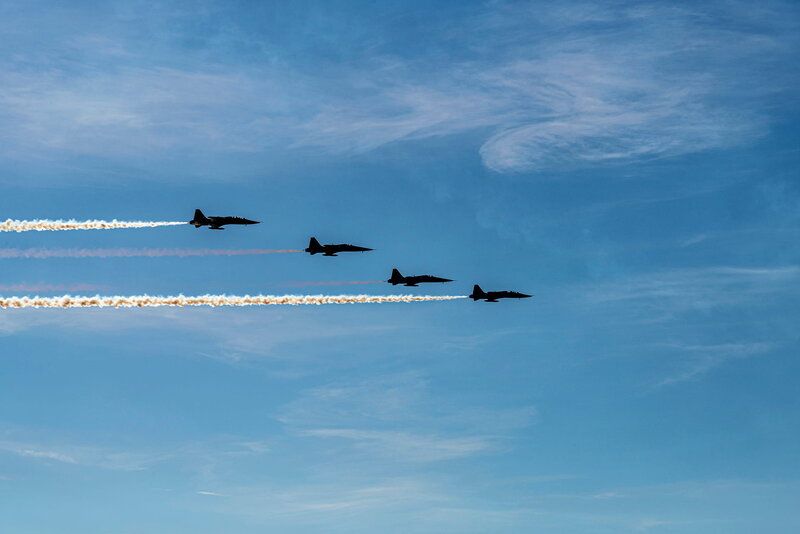 4 planes in the sky performing at an airshow