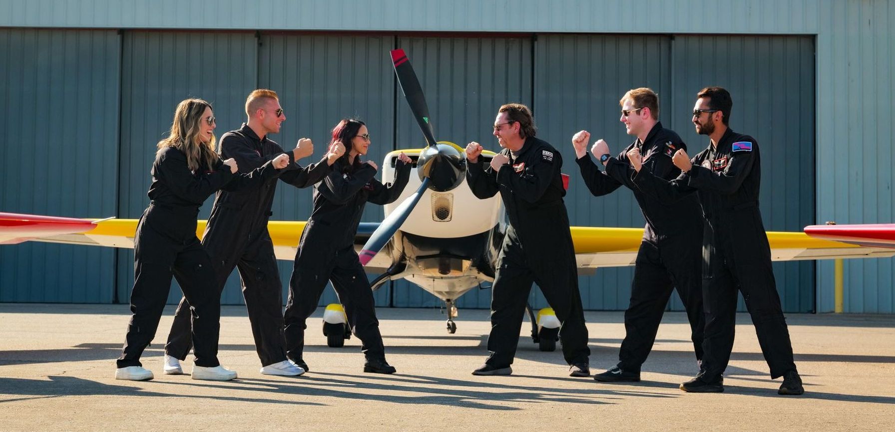 A group of people standing in front of an airplane
