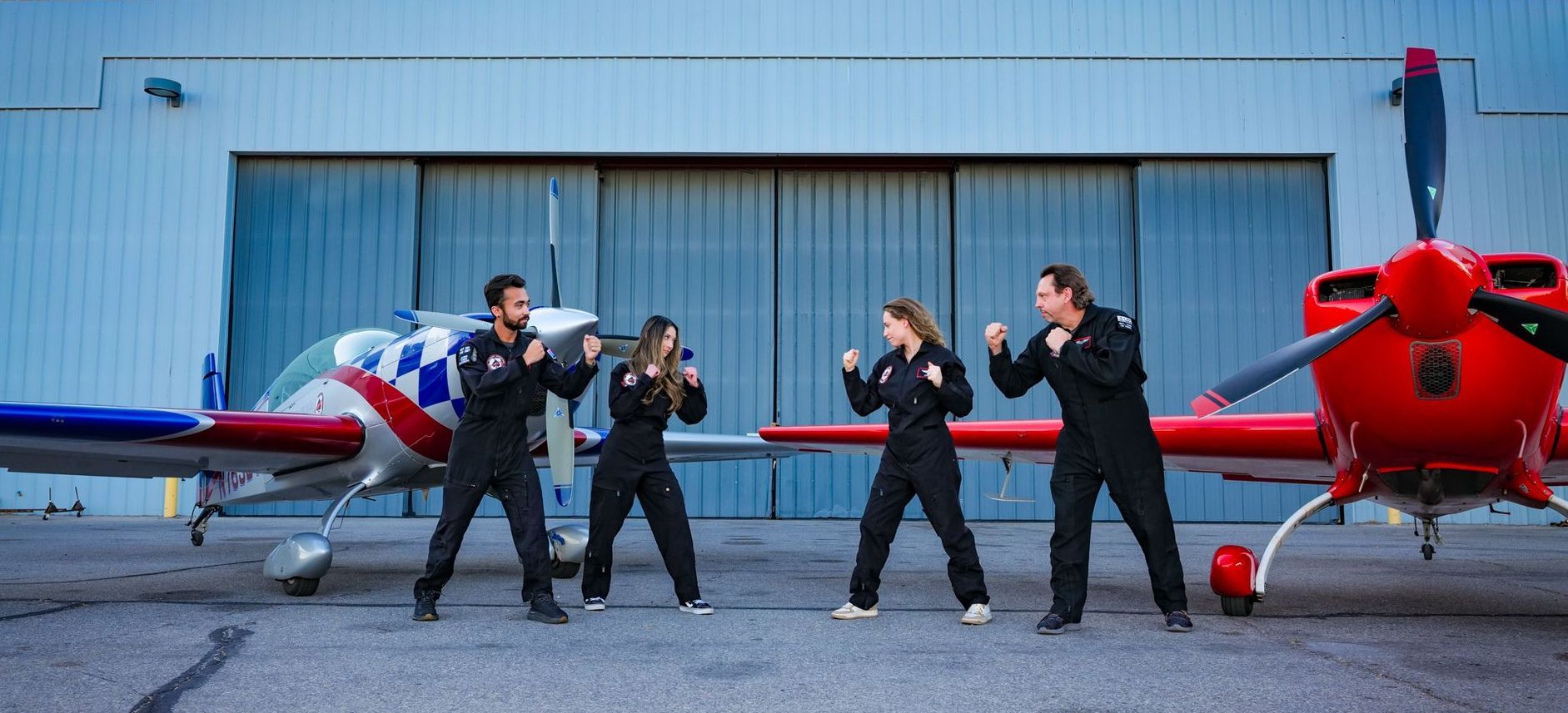 A group of people standing in front of an airplane