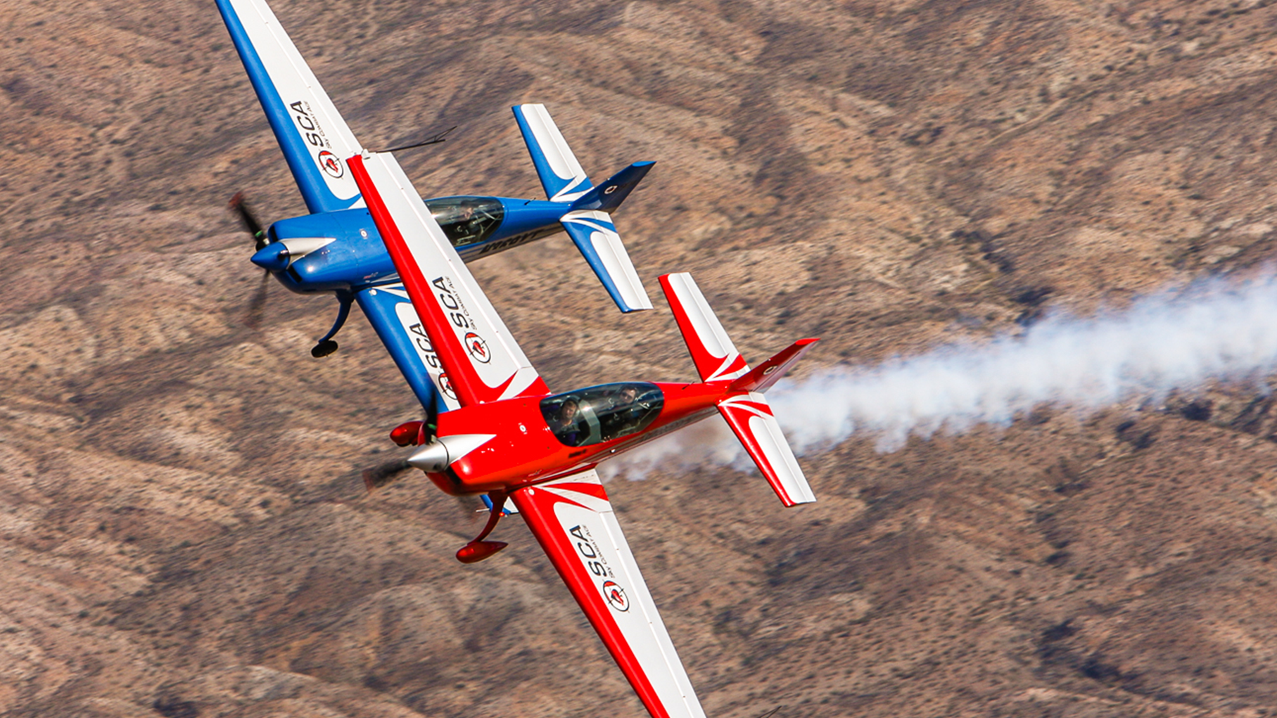 Two aircraft in an air-to-air dogfight over the desert