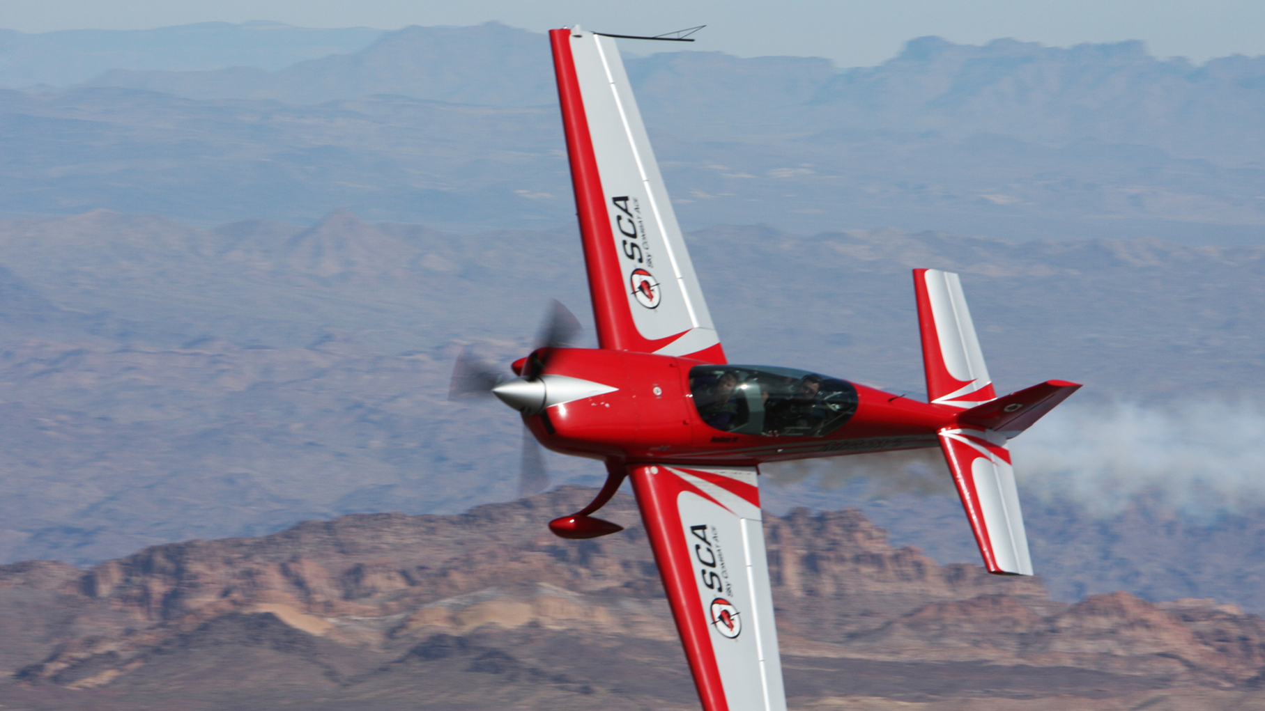 Aircraft banking low over the desert