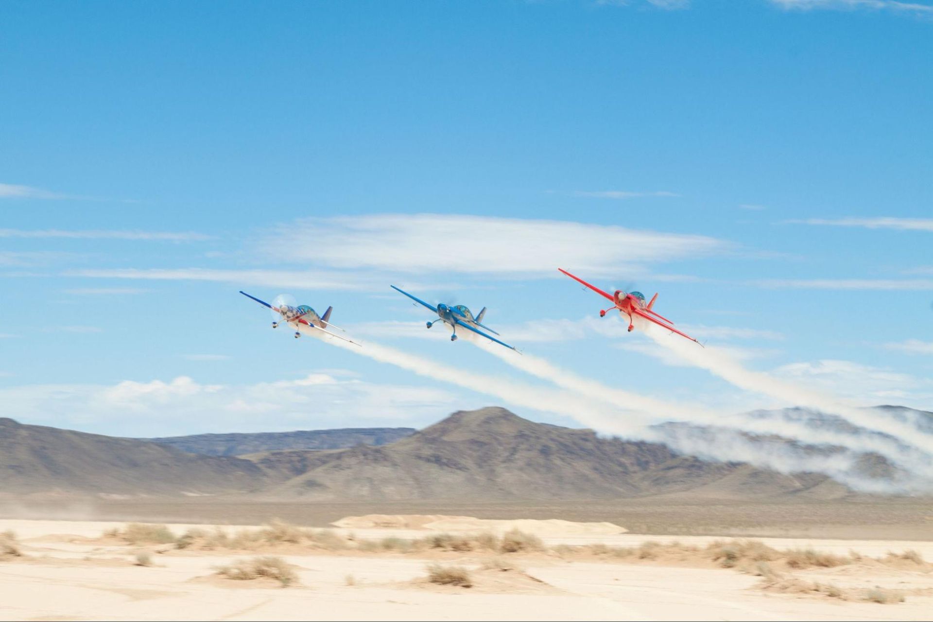 Three Sky Combat Ace airplanes flying in formation.