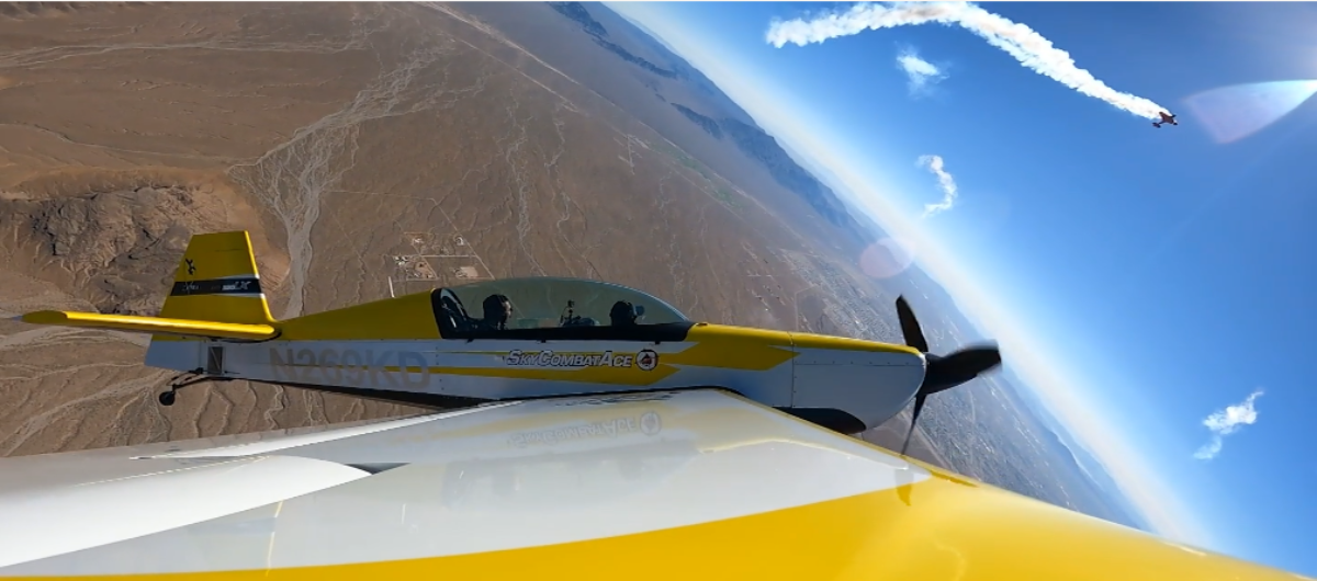 A yellow and white plane is flying in the sky.