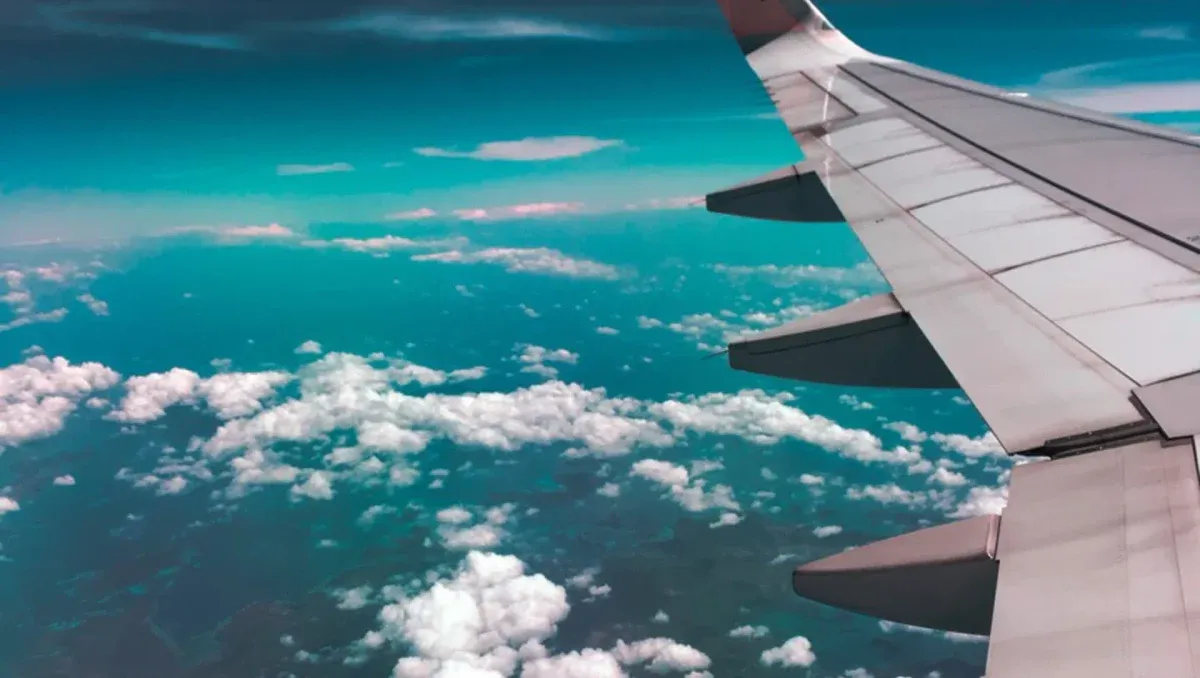 Monoplane wing flying over clouds