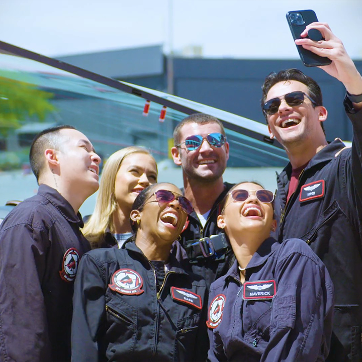 A man is taking a selfie with a group of people
