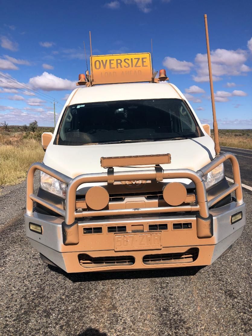 A White Van with A Yellow Sign on Top that Says Oversized — Col Adamson Transport Pilot Services In Farleigh, QLD