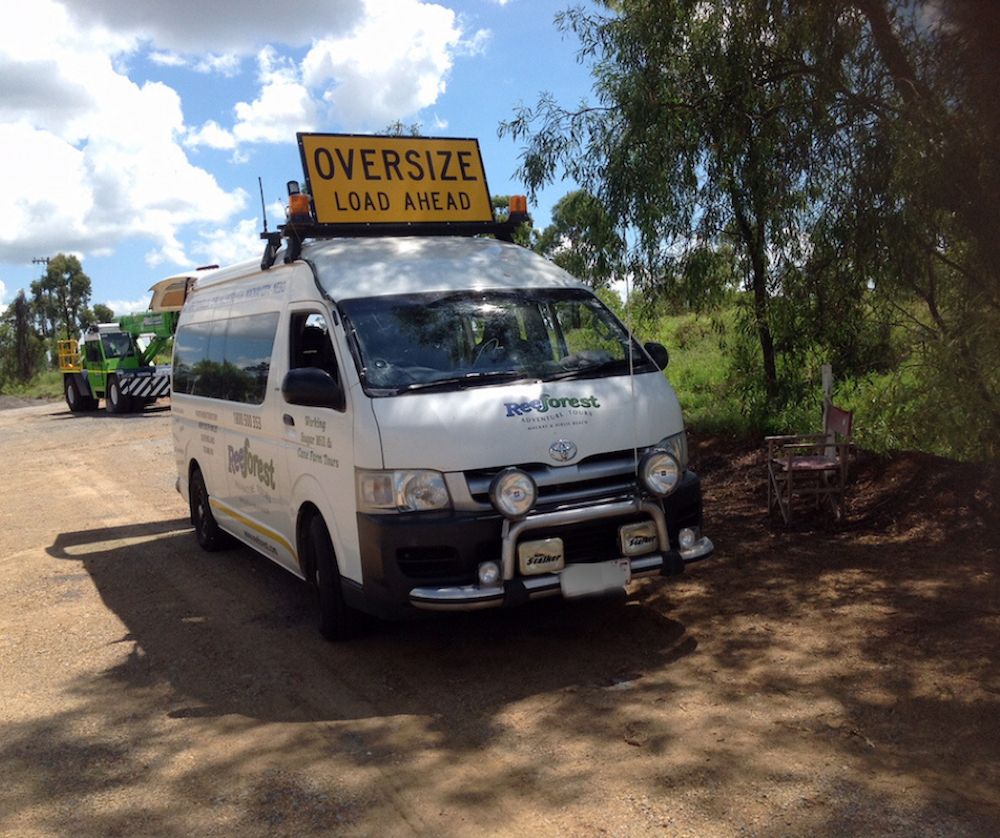 A White Van With a Yellow Sign on Top That Says Oversize — Col Adamson Transport Services in Farleigh, QLD