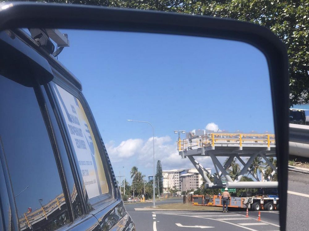 The Mirror of a Car Shows a Bridge Carrying by a Big Truck — Col Adamson Transport Services in Farleigh, QLD