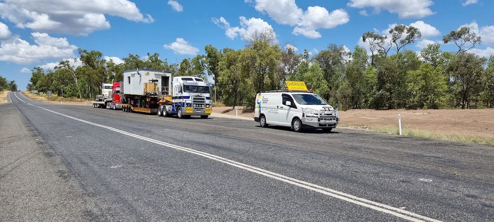 A Truck and a Van Are Driving Down a Highway — Col Adamson Transport Services in Farleigh, QLD