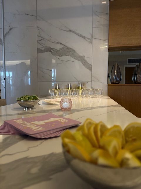 Photo of a bar setting with slices of limes and lemons and empty plastic cups sitting in the background.