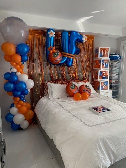 A bedroom where the bed is decorated representing the University of Florida.