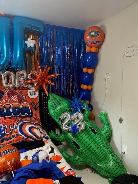 A bedroom decorated for the University of Florida with an alligator.
