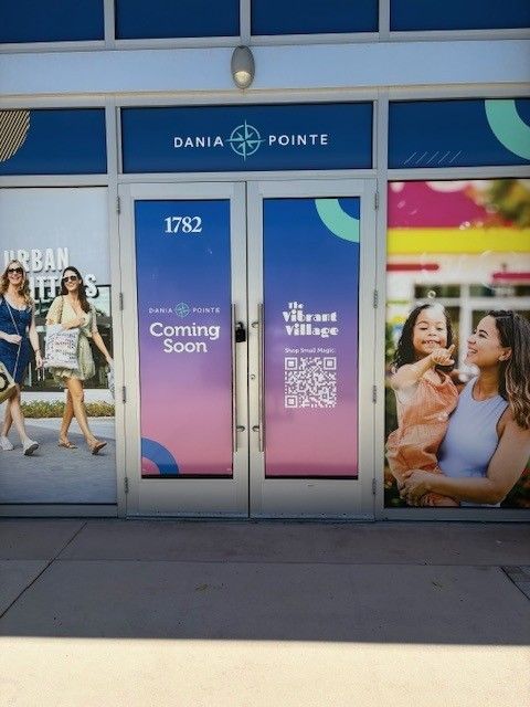 A photo of the coming soon barricade at The Vibant Village inside the Dania Pointe.