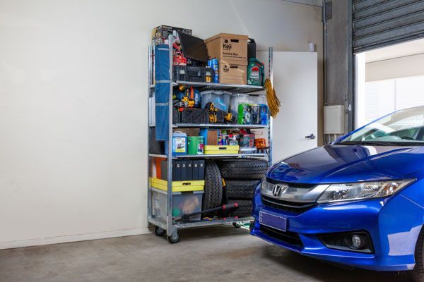 A blue honda civic is parked in a garage.