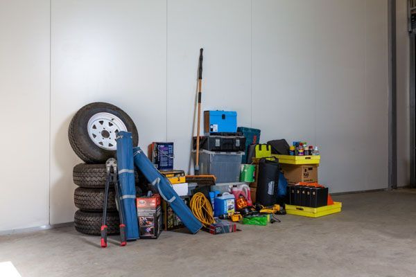 A garage filled with lots of tools and tires.