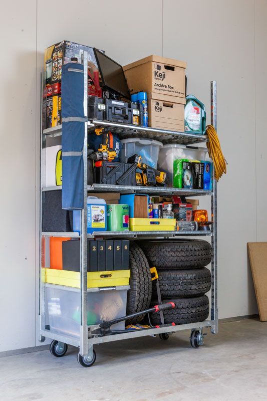 A metal cart with a metal tray on top of it.