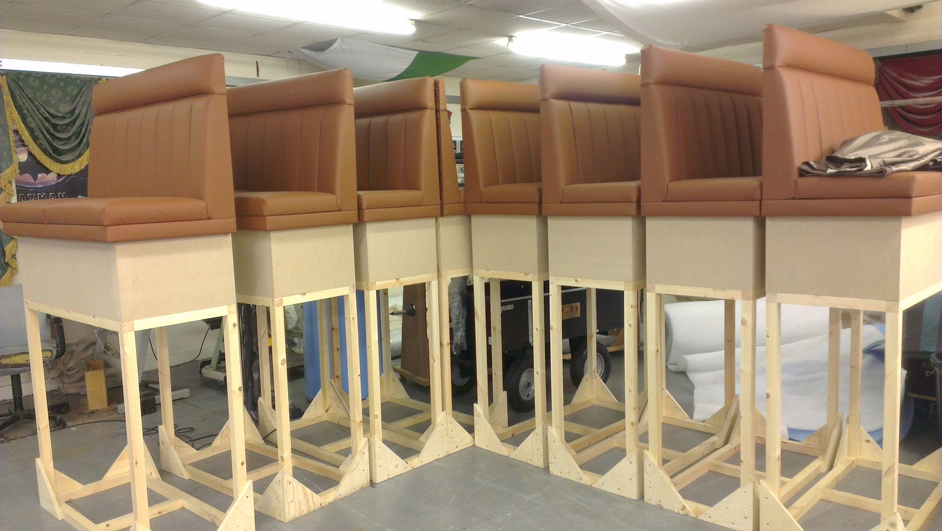 Banquette seating raied oon long legs to allow puppet actors underneath.